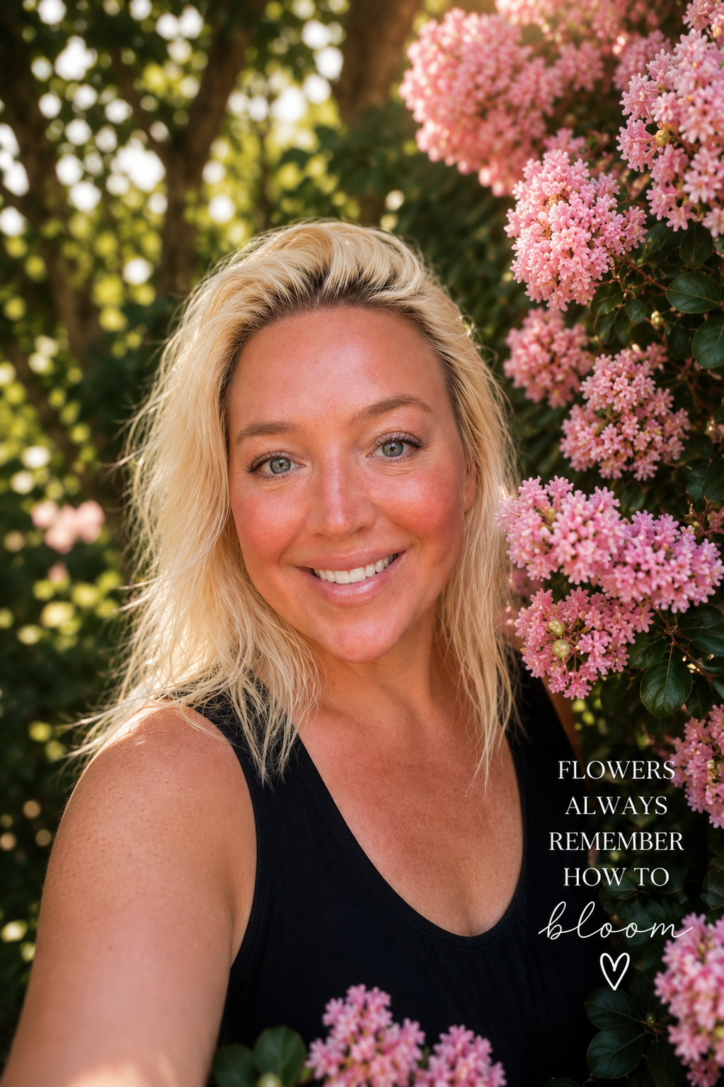 Author Andrea Perullo among pink blossoms in golden hour light